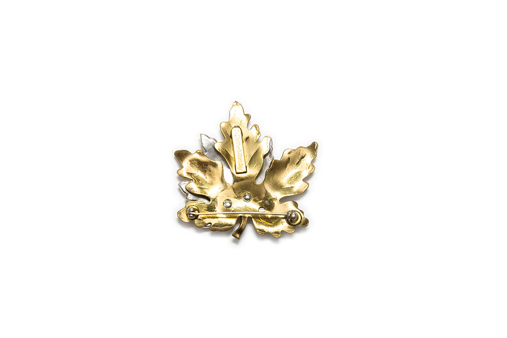 back view of gold-plated maple leaf brooch with maker mark "McClelland Barclay"