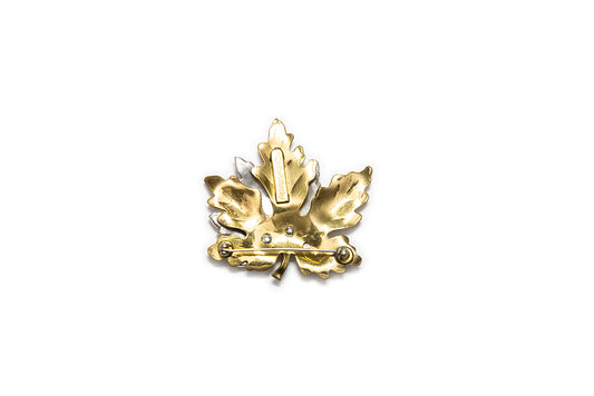 back view of gold-plated maple leaf brooch with maker mark "McClelland Barclay"