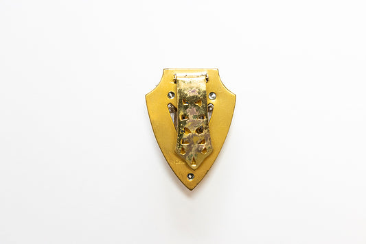 back view of shield shaped MCCLELLAND BARCLAY Art Deco gold plated dress clip with blue and clear rhinestones