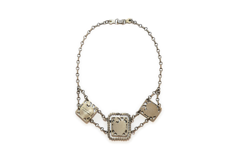back view showing McClelland Barclay sterling silver mark on vintage 1930s Art Deco necklace with hearts and flowers in three plaques linked together