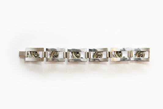 Back view of rhodium plated silvertone Art Moderne link bracelet has blue navettes and clear rhinestones. Made 1938 - 1940 and signed McClelland Barclay.