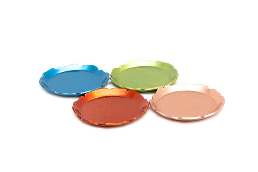 Four vintage 1930s McClelland Barclay round aluminum scalloped-edge coasters in blue, green, orange, and rose gold, arranged on a plain white background.