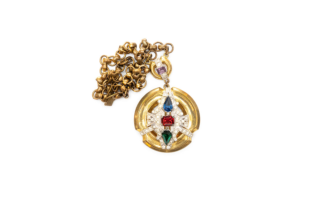 detail of McClelland Barclay gold-plated medallion pendant with blue, red, green, purple and clear rhinestones