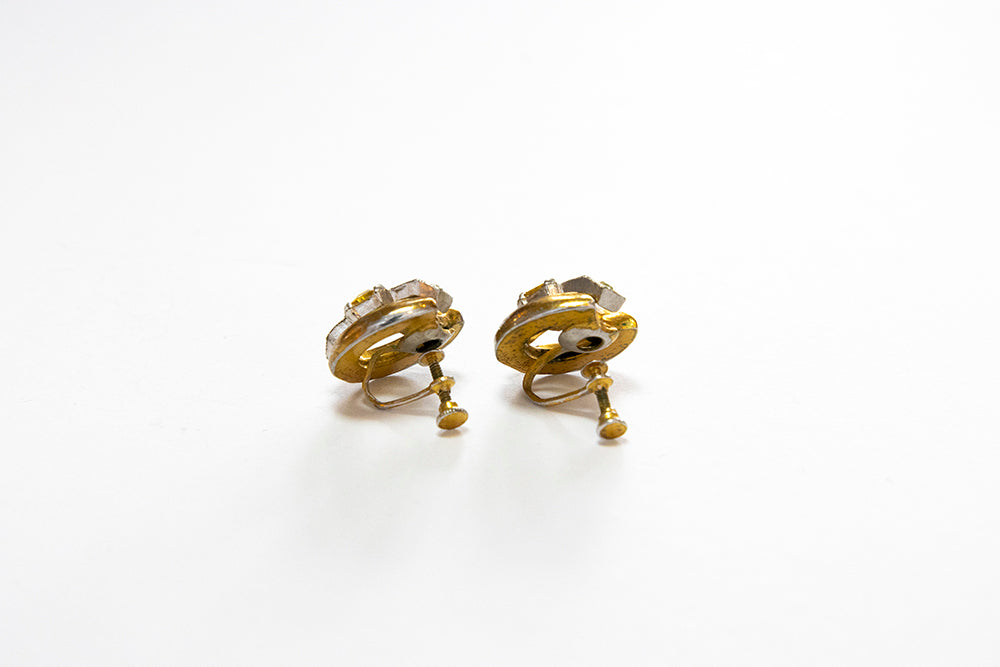 Back view of pair of vintage gold plated screwback earrings on a white background