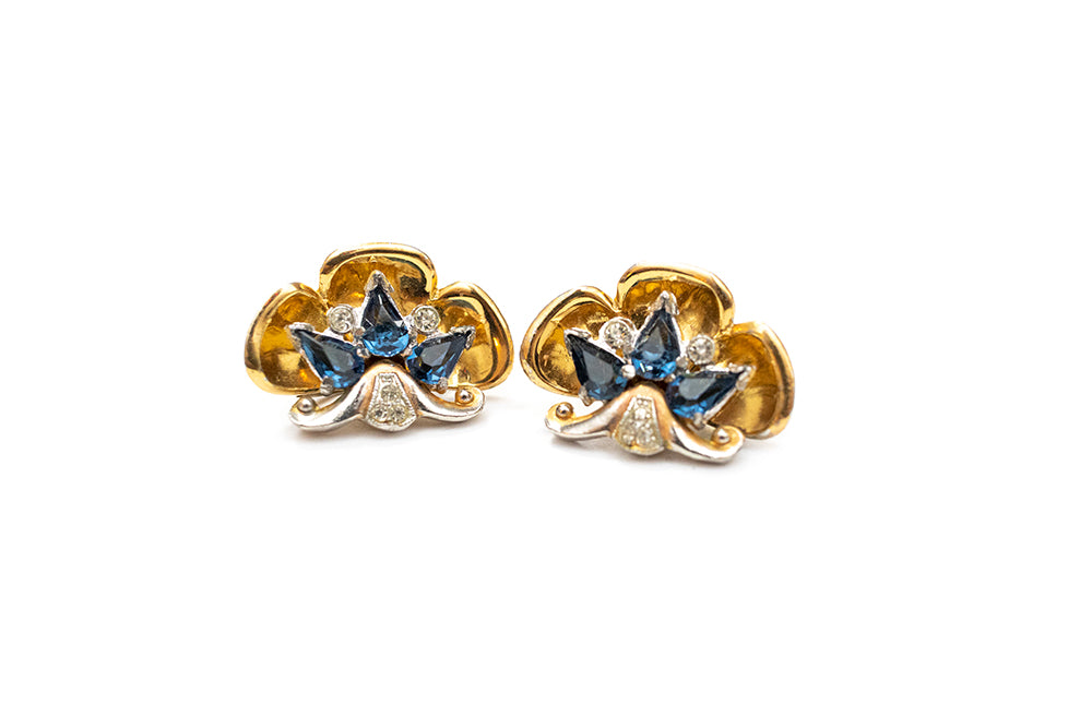 pair of gold scalloped dress clips with sapphire blue rhinestones
