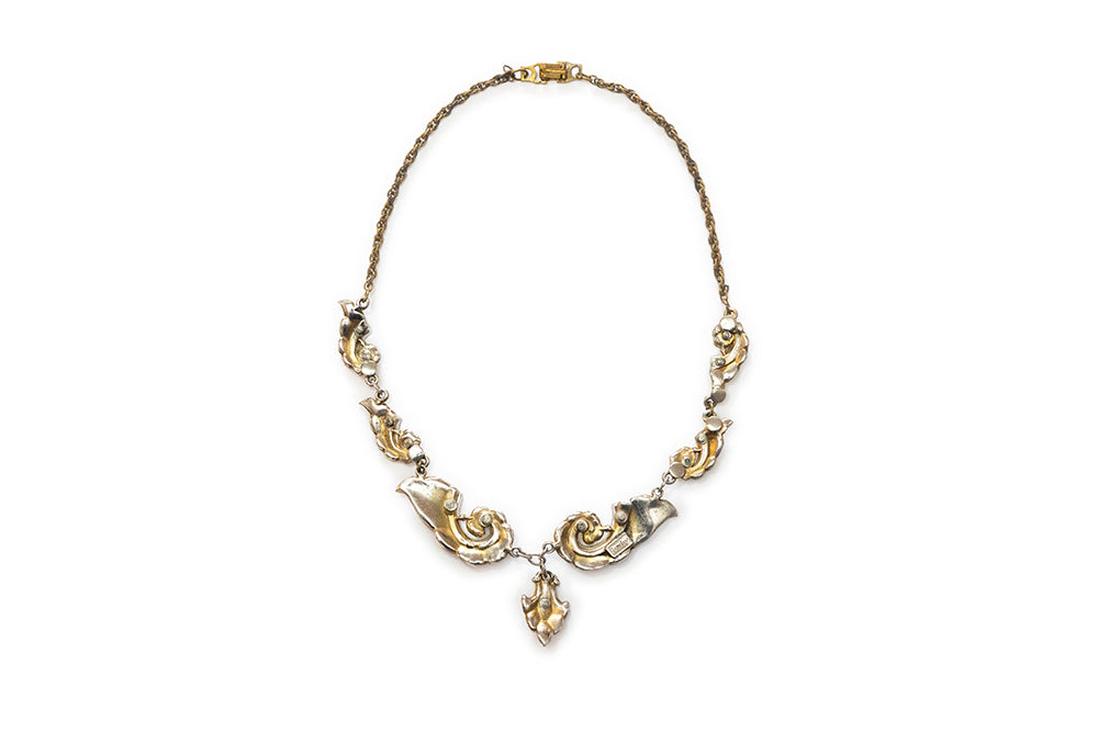 Back view of McClelland Barclay vintage gold plated necklace with swirl design