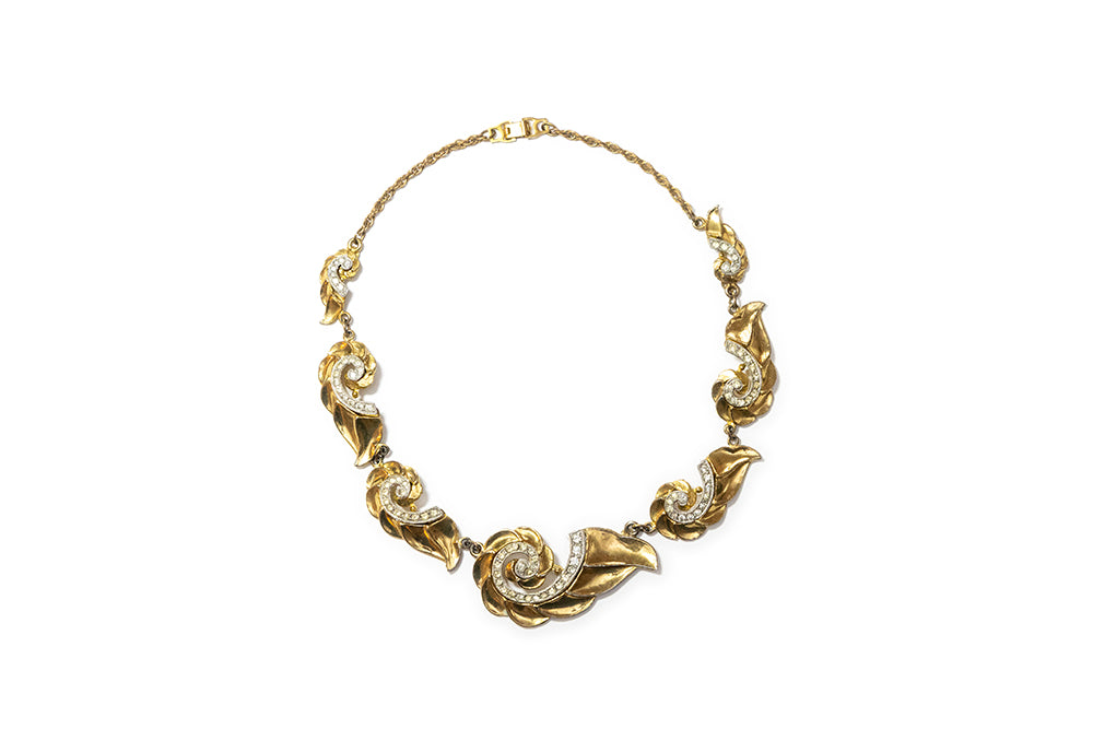 Vintage gold-plated choker necklace with graduated swirl design embellished with clear rhinestones on a white background