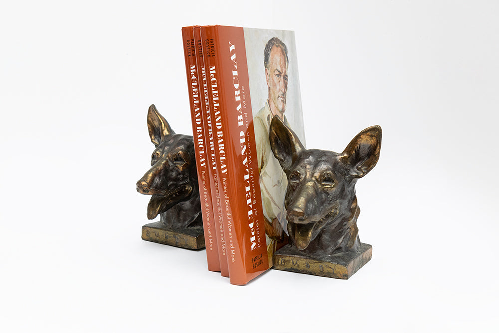 "Buddy" metal bookends by McClelland Barclay Art Products, Inc. hold the new illustrated biography of the artist: McClelland Barclay: Painter of Beautiful Women and More by Patricia Gostick