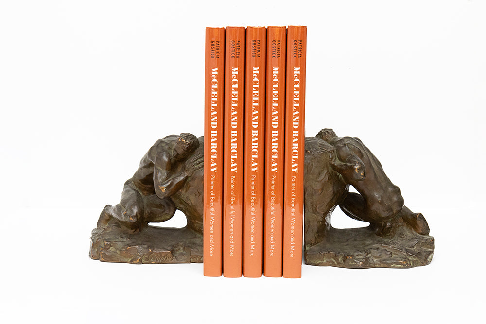 Pair of bronze plated bookends depicting Sisyphus of Greek mythology pushing the boulder uphill. Made by McClelland Barclay Art Products in the 1930s they are shown holding 5 copies of the illustrated biography book of the artist by Patricia Gostick