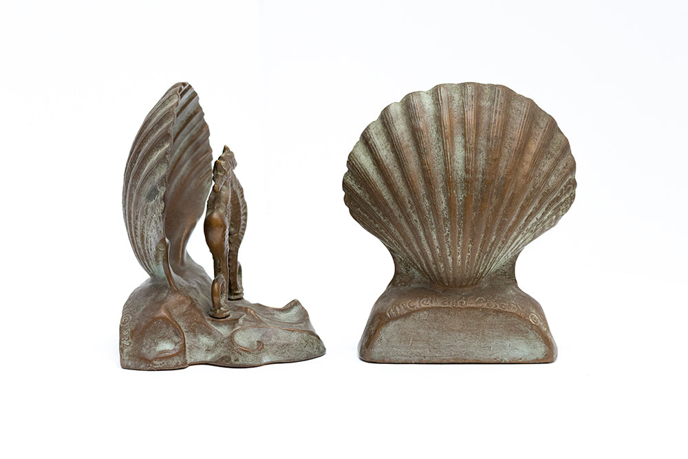 Side and back view of McClelland Barclay seahorse and shell bookends from the 1930s. Stamped McClelland Barclay © signature shoows on back