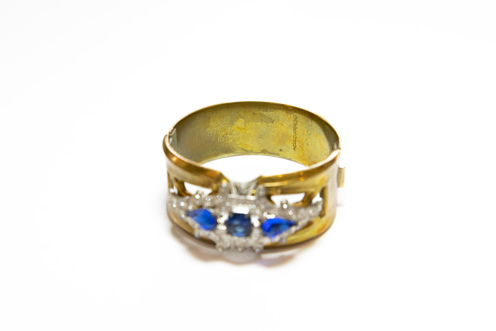 Signature on inside of Art Deco hinged cuff blue rhinestone bracelet by McClelland Barclay