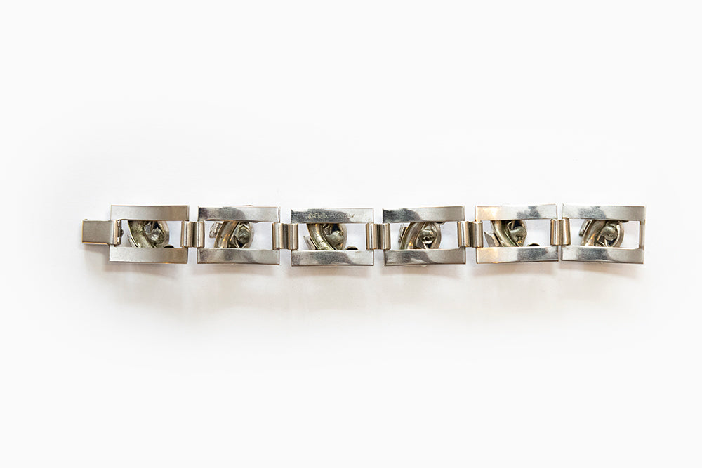 Back view of rhodium plated silvertone Art Moderne link bracelet has blue navettes  and clear rhinestones. Made 1938 - 1940 and signed McClelland Barclay.
