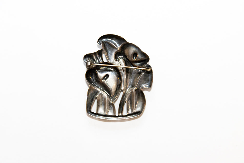 the open back view of this McClelland Barclay Art Deco sterling silver lillies brooch shows the repoussé , or hammered from behind technique